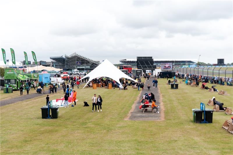 Aerial view of Silverstone fan zone with star tent, food vendors and grandstands during F1 weekend